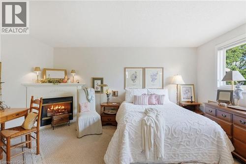 White walls with neutral carpeting, a gas fireplace - 89 Brigade Drive, Hamilton, ON 