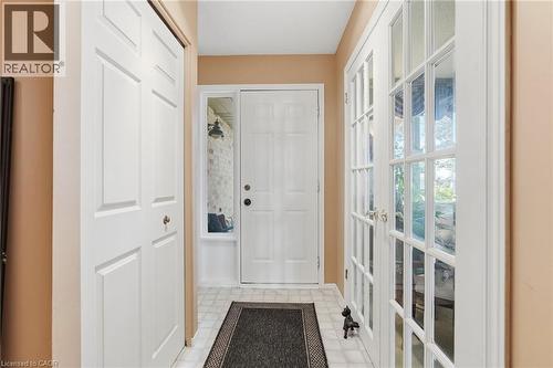 Entryway featuring a white paneled door, French doors with glass panes - 89 Brigade Drive, Hamilton, ON 
