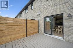 Composite deck with a horizontal wood privacy fence and a light brick exterior - 