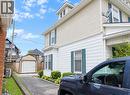 Two-story exterior with light-colored siding, green window shutters, and a bay window - 60 Lynnwood Avenue, Simcoe, ON 