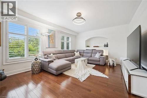 Hardwood flooring, plantation shutters, recessed wall niche, and built-in shelving - 517 Topper Woods Crescent, Kitchener, ON 