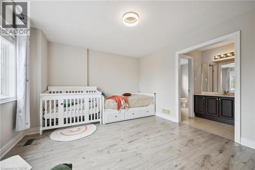 Light wood-finish flooring, neutral wall tones, and recessed lighting - 517 Topper Woods Crescent, Kitchener, ON 