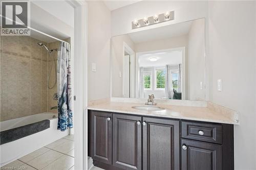 Vanity with a light-toned countertop, undermount sink, and dark wood-finish cabinetry - 517 Topper Woods Crescent, Kitchener, ON 