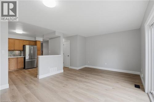 Open concept living space featuring wood-finish flooring, light gray wall tones, and recessed lighting - 30 S Imperial Road Unit# 3, Guelph, ON 