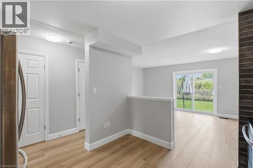 Wood-finish flooring throughout, with white trim and interior doors - 30 S Imperial Road Unit# 3, Guelph, ON 