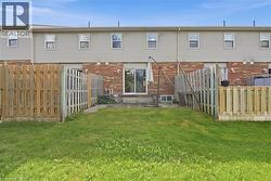 Private fenced yard with patio area and sliding glass door access - 