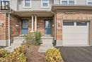 Brick and siding exterior with concrete steps, covered entry, and integrated garage featuring transom windows - 30 S Imperial Road Unit# 3, Guelph, ON 