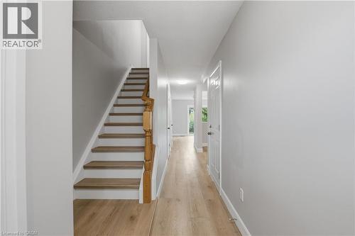 Hallway featuring wood-finish flooring and light gray painted walls - 30 S Imperial Road Unit# 3, Guelph, ON 