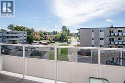 Balcony with a glass railing and white privacy panels - 