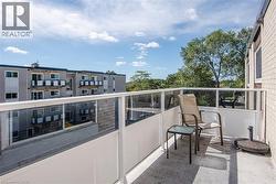 Balcony featuring a glass panel railing and concrete flooring - 