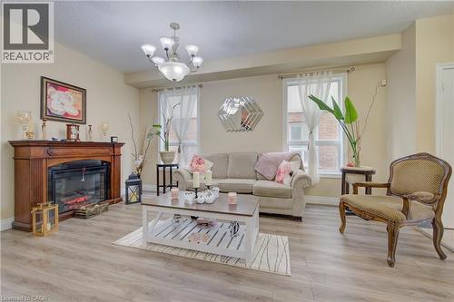Wood-finish flooring, recessed lighting, chandelier, fireplace with wood mantel - 78 Stuckey Avenue, Baden, ON 