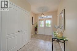 Front entry featuring double doors with glass and tile flooring - 