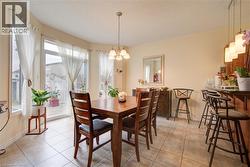 Tiled flooring, multiple large windows, and a sliding glass door - 