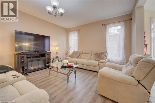 Open concept living space featuring wood-finish flooring, recessed lighting, and a chandelier - 78 Stuckey Avenue, Baden, ON 