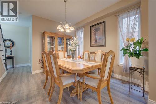 Dining area featuring wood-finish flooring, two window openings, and a chandelier lighting fixture - 78 Stuckey Avenue, Baden, ON 