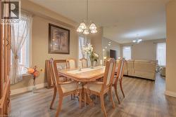 Open-concept interior featuring wood-finish flooring, recessed lighting, and a chandelier-style light fixture - 