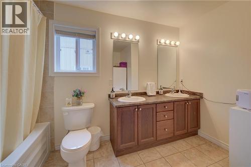 Light wood-finish flooring, single window with white curtains, neutral wall paint, and a ceiling-mounted light fixture - 78 Stuckey Avenue, Baden, ON 