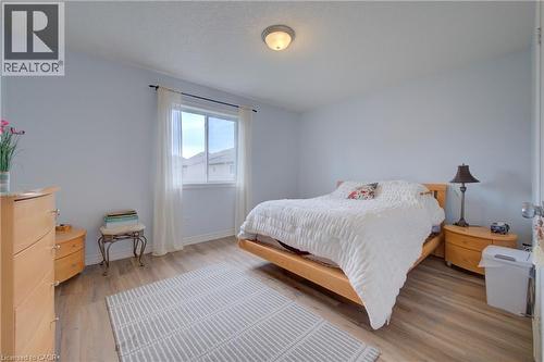 Wood-finish flooring throughout, bright white walls, and a window with blinds - 78 Stuckey Avenue, Baden, ON 