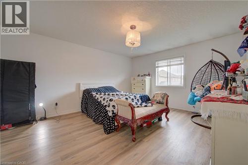 Wood-finish flooring throughout the hallway, neutral wall tones, and white trim - 78 Stuckey Avenue, Baden, ON 
