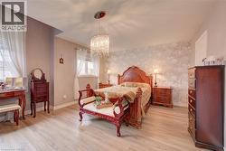 Recessed lighting, wood-finish flooring, and a decorative accent wall - 