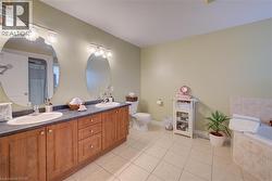 Double vanity with wood-finish cabinetry, dual sinks, and two  mirrors - 