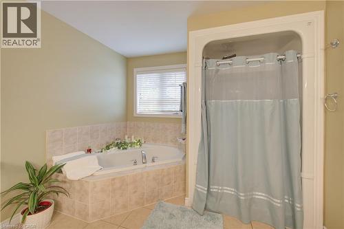 Soaking tub with tiled surround, separate shower enclosure, and tiled flooring - 78 Stuckey Avenue, Baden, ON 