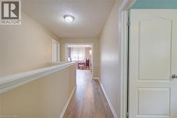 Wood-finish flooring with neutral wall paint and white trim - 