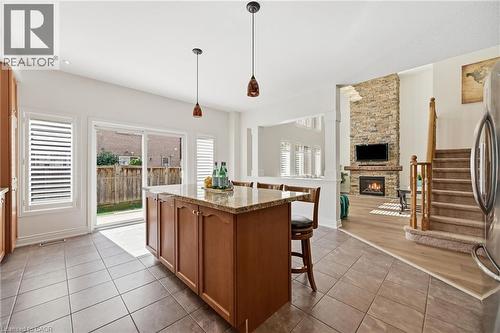 Kitchen island with a light-toned countertop, tile flooring, and sliding glass door - 3198 Tim Dobbie Drive, Burlington, ON 