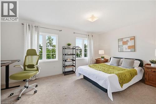 Carpeted flooring, white walls, two windows with white trim, and a ceiling-mounted light fixture - 3198 Tim Dobbie Drive, Burlington, ON 