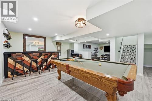 Recreation room featuring a built-in bar, wood-finish flooring, recessed lighting, and a billiard table - 3198 Tim Dobbie Drive, Burlington, ON 
