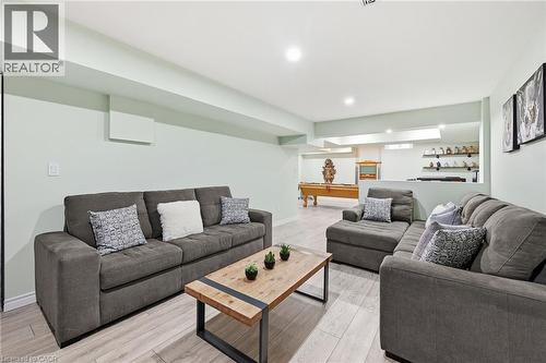 Recessed lighting illuminates the space, featuring light wood-finish flooring - 3198 Tim Dobbie Drive, Burlington, ON 
