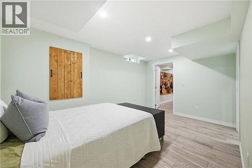 Recessed ceiling lighting, wood-finish flooring, light-toned wall paint, and a wood panel feature - 3198 Tim Dobbie Drive, Burlington, ON 