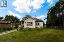 Single-story residence featuring light-colored siding, a covered porch entry, and multiple windows - 1412 Old York Road, Burlington, ON 