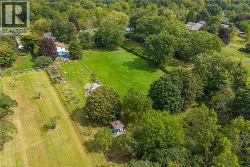 Expansive green space featuring large grass areas, a rectangular garden bed, a small gazebo structure, and mature trees - 1412 Old York Road, Burlington, ON 