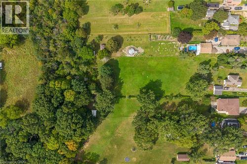Expansive land parcel featuring a lush green lawn, mature trees, and natural wooded areas - 1412 Old York Road, Burlington, ON 