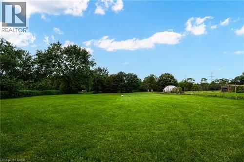 Expansive green lawn with mature perimeter trees and a translucent dome structure - 1412 Old York Road, Burlington, ON 