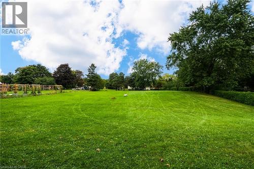 Expansive green lawn with mature trees and a structured garden area - 1412 Old York Road, Burlington, ON 