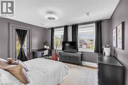 Recessed lighting, wood-finish flooring, ceiling fan, multiple windows with natural light, and a door to an outdoor area - 