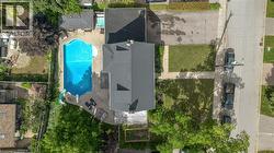 Backyard featuring an in-ground swimming pool with surrounding concrete patio - 
