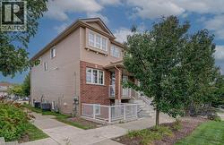 Multi-story exterior with horizontal siding and brick accents - 