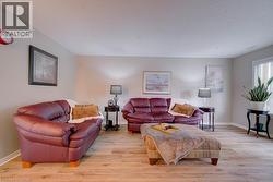 Light wood-finish flooring throughout, neutral wall tones, and recessed window - 