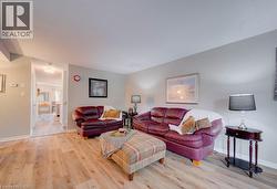 Light wood-finish flooring throughout, neutral wall paint, and recessed ceiling lighting - 