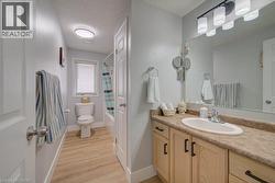 Vanity with an integrated sink, broad mirror, and a three-light fixture - 