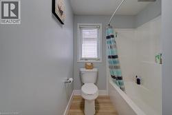 White paneled tub and shower combination with a curved shower rod - 