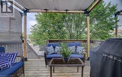 Wood-finish deck with a pergola and retractable shade cover - 