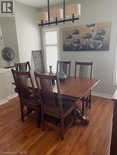 Hardwood flooring, window with plantation shutters, ceiling-mounted linear chandelier - 5383 Haldimand Crescent, Burlington, ON 