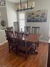 Hardwood flooring, window with plantation shutters, ceiling-mounted linear chandelier - 5383 Haldimand Crescent, Burlington, ON 