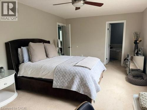 Carpeted room with a ceiling fan, recessed lighting, and access to an ensuite bathroom featuring a tub - 5383 Haldimand Crescent, Burlington, ON 