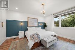 Primary bedroom w hanging fixture. - 