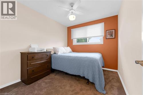 Bedroom featuring carpeted flooring, a window with a roller blind, and a ceiling fan - 7506 Jubilee Drive, Niagara Falls, ON 